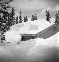 BW Photos showing rangers digging out the visitor center from snowdrift.