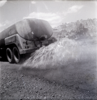 Construction vehicle spraying chipsealing of Kolob Canyon Road.