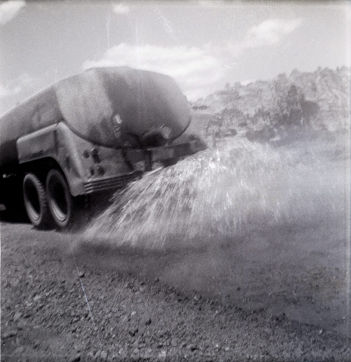 Construction vehicle spraying chipsealing of Kolob Canyon Road.