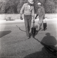 Men filling cracks in the road along the scenic canyon drive near the Grotto.