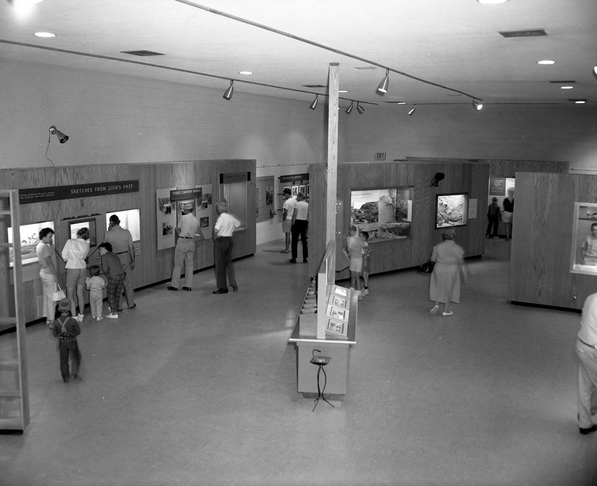 Interior of the Zion Museum space with visitors and children looking at exhibits.