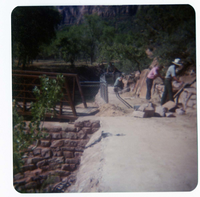 Men working on trail by the new Grotto footbridge.