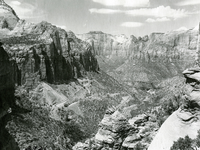 View from Canyon Overlook Trail towards Zion-Mt. Carmel Highway Switchbacks, Standard oil Company photo. [Negative is colorized with reddish color]