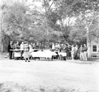 Men and women from the Fire Conference gathered outside for barbecue feast, April 1957. Near ranger dormitory.