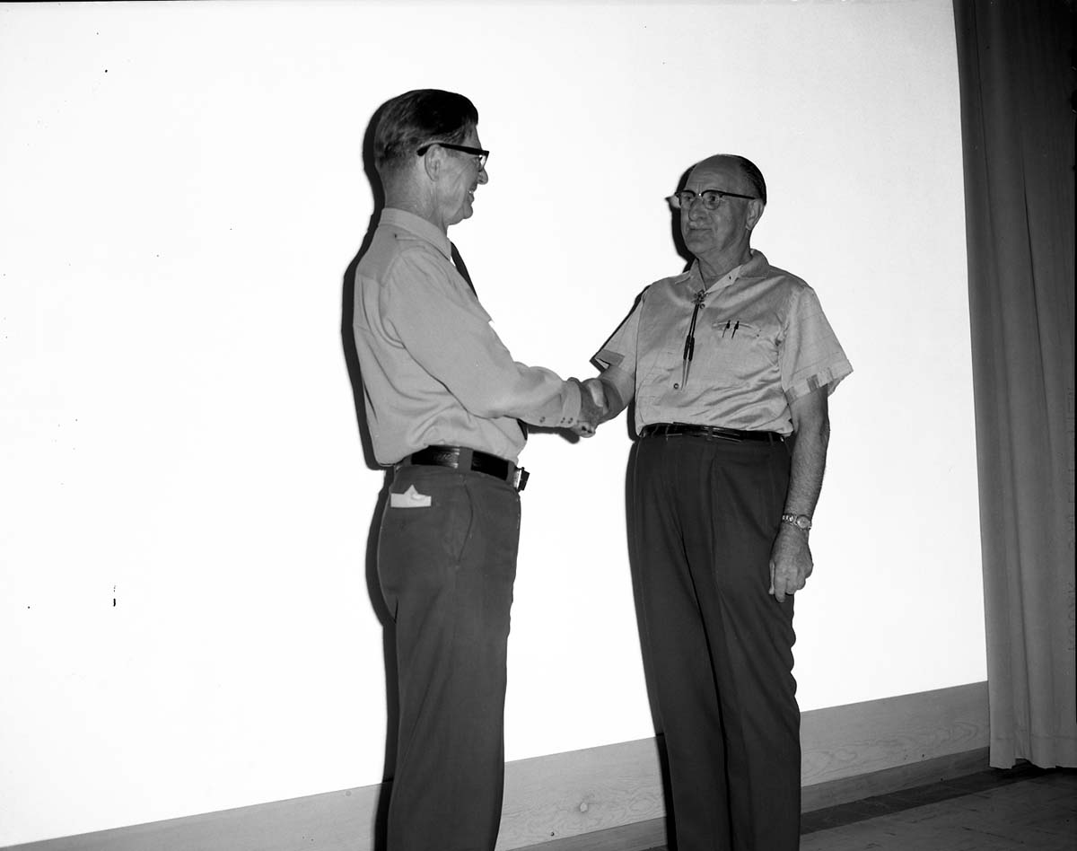 Superintendent Warren F. Hamilton presents award to Administrative Officer Sidney B. Ellis.