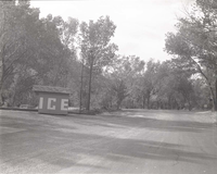 Ice shed and parking area with surrounding trees in the South Campground.