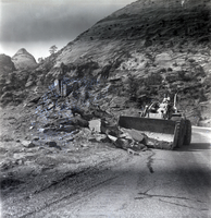Construction vehicle clearing rocks during east side road repair and turn out construction.