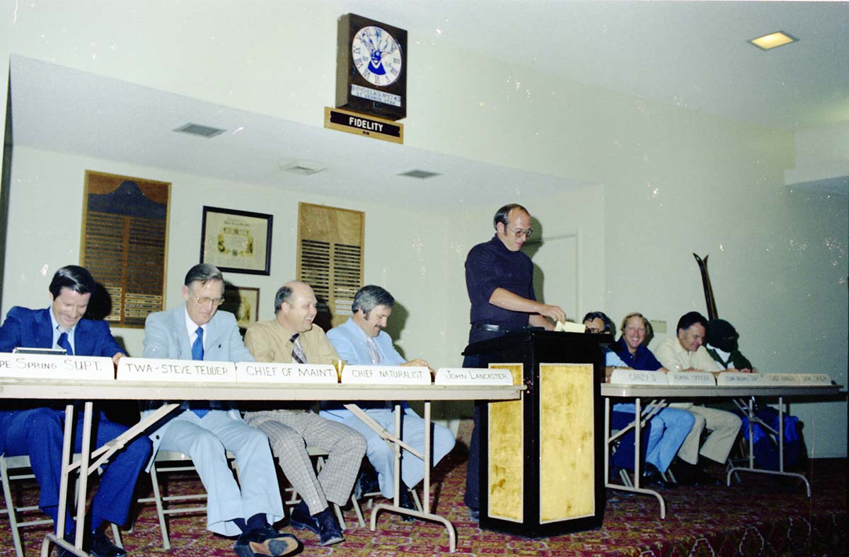 Color Photos of John Lancaster's farewell party at Elks Club in St. George, Utah. Speakers at roast in front of room: Pipe Spring National Monument Superintendent, TWA Steve Tedder, Chief of Maintenance, Chief Naturalist, John Lancaster, Crazy D, Administrative Officer, Cedar Breaks National Monument Superintendent, Chief Ranger, Unknown Skier.