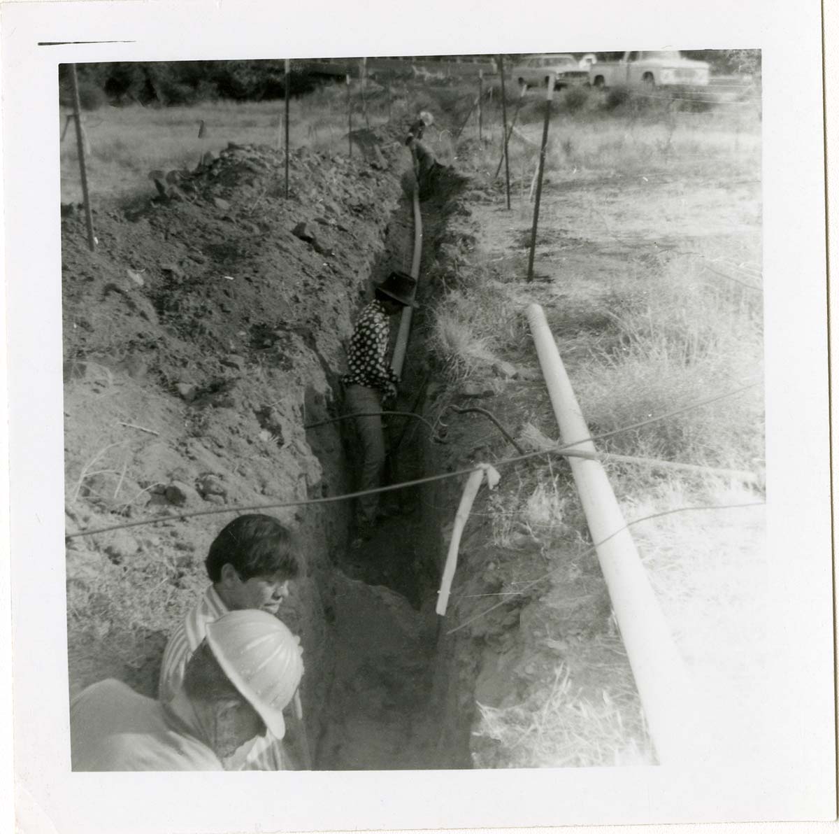 Workers digging ditch during the Watchman housing utility project.