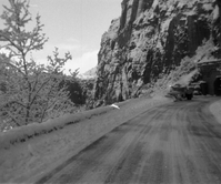 BW photos of Snow plowing road at entrance to tunnel west.