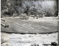 Construction of million gallon water tank at Birch Creek - laying steel plate for floor.