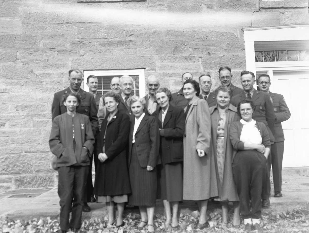 Men and women attendees of the All-Area Staff Meeting pose in front of the ranger dormitory. Meeting held at Zion National Park on December 5, 1952.