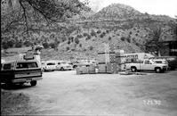 Parking lot with construction vehicles and building materials during the construction of headquarters addition.
