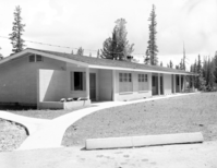 The front yard view of multiplex during landscaping in the residential area, parking area and walkway completed.