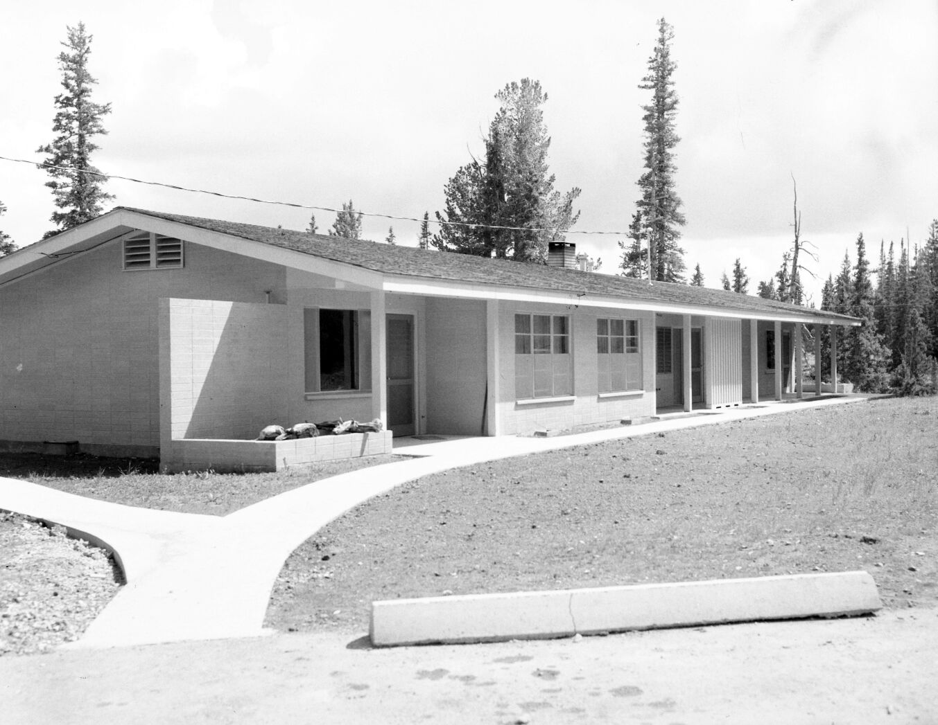 The front yard view of multiplex during landscaping in the residential area, parking area and walkway completed.