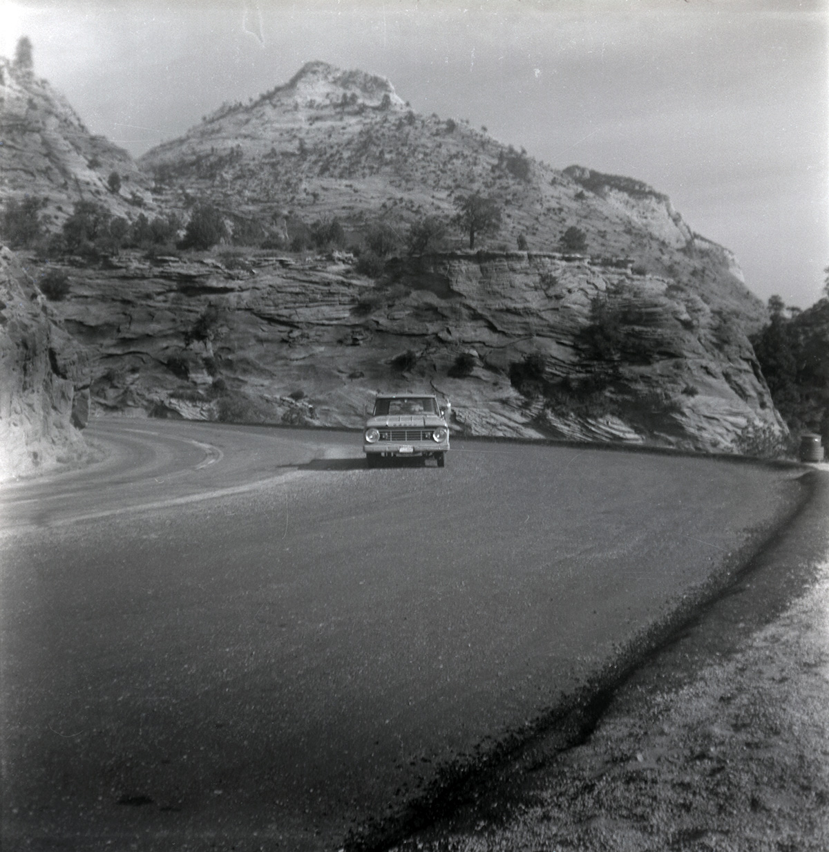 Truck driving down road during east side road repair and turn out construction.