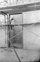 Man worker laying bricks during the construction of headquarters addition.