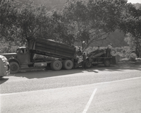Men operating sealcoating machine while sealcoating parking area in Zion.