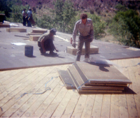 Workers placing roofing sheets during the headquarters/visitor center roofing project.