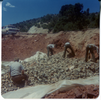 Men working in rock pile during road work/repair in Kolob Canyon.