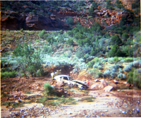 Color photos of park personnel removing a car from the flood waters of the 1975 flood.