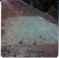 Tarp laid out over dirt and rocks during road work/repair in Kolob Canyon.