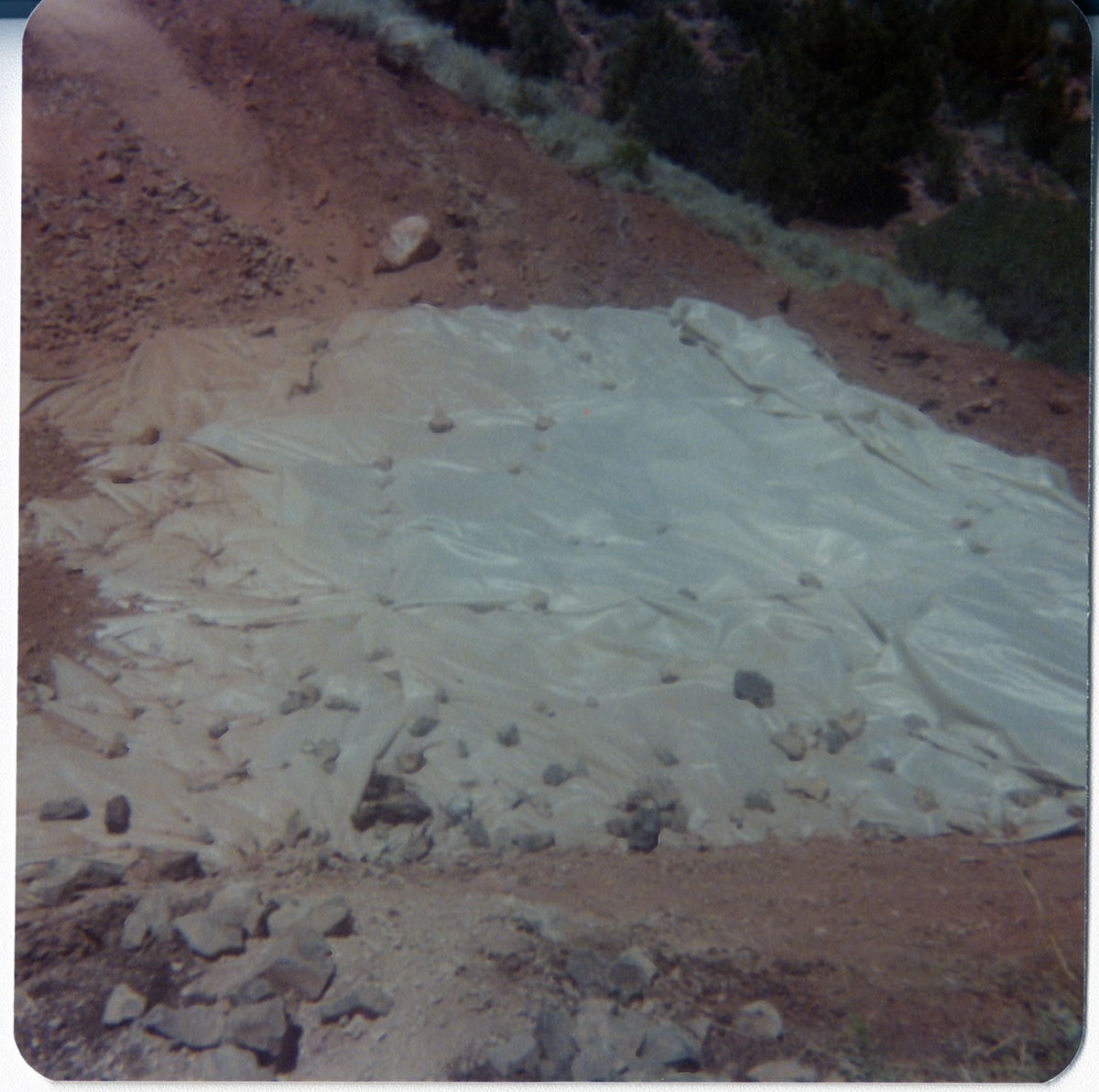 Tarp laid out over dirt and rocks during road work/repair in Kolob Canyon.