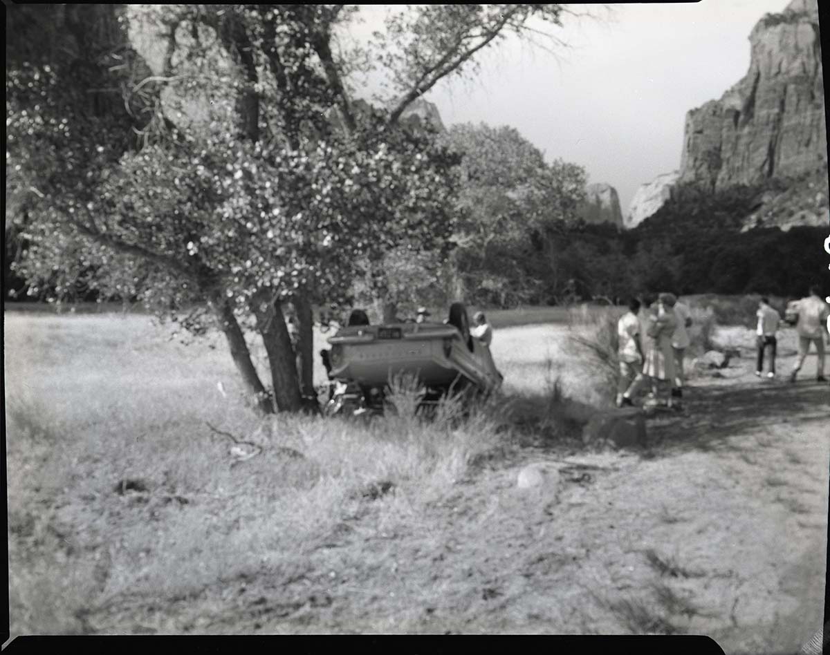 Auto accident 6 miles south of Zion Lodge. Car overturned just off road.