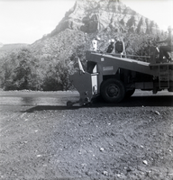 Men operating construction vehicle during chipsealing of Kolob Canyon Road.