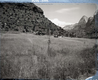 Pilot module from F-111 aircraft that crashed behind Zion Lodge July 11, 1973 helicopter and truck from Nellis Air Force Base loading module near field in front of Visitor Center.