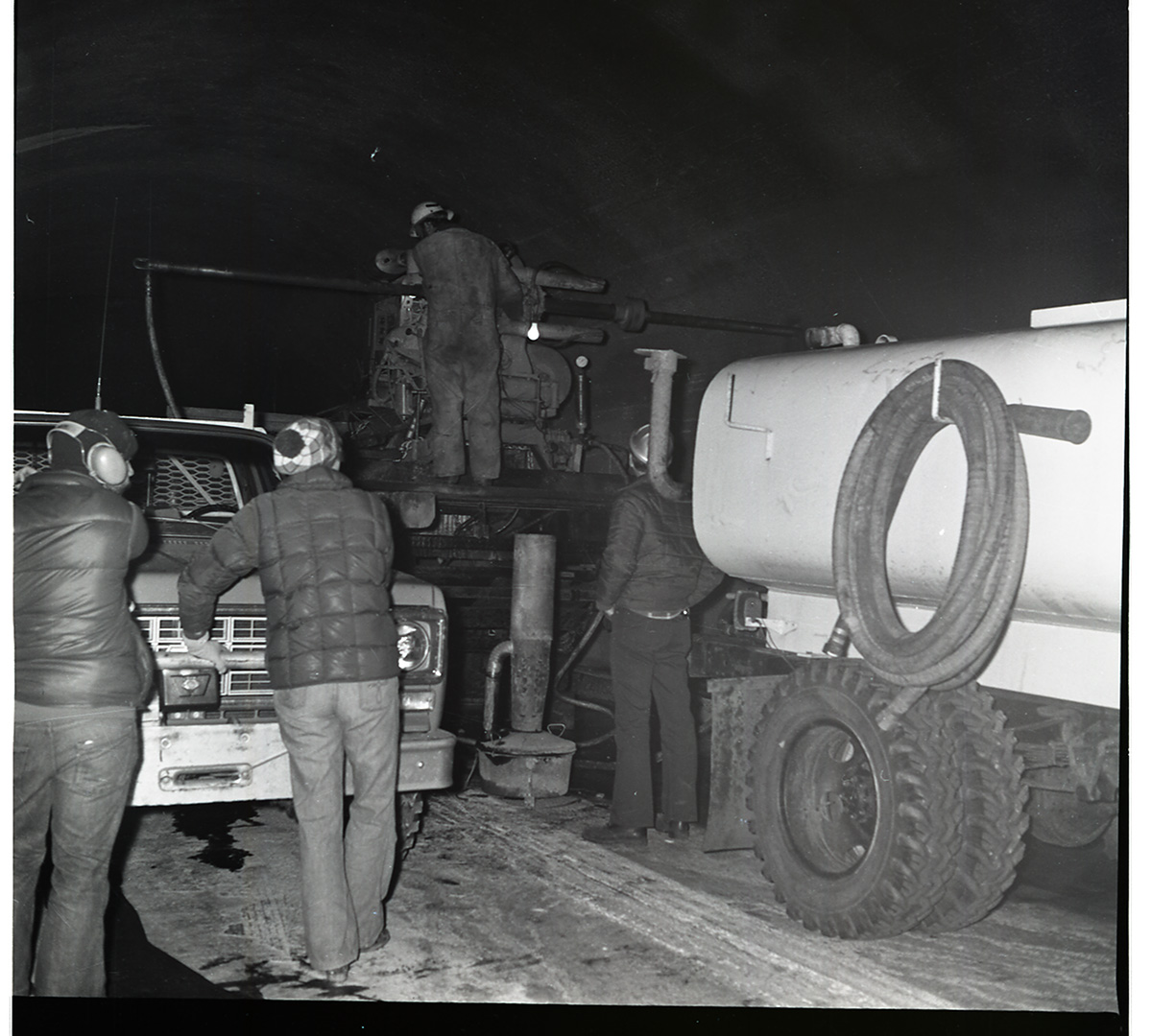 Worker works with drill rig during test hole drilling in Zion-Mt. Carmel tunnel.
