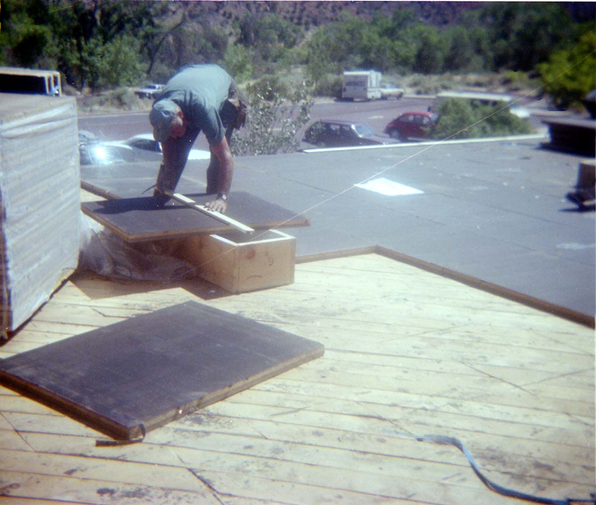 Man laying tiles during the headquarters/visitor center roofing project.