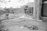 Workers performing construction duties during the construction of headquarters addition.