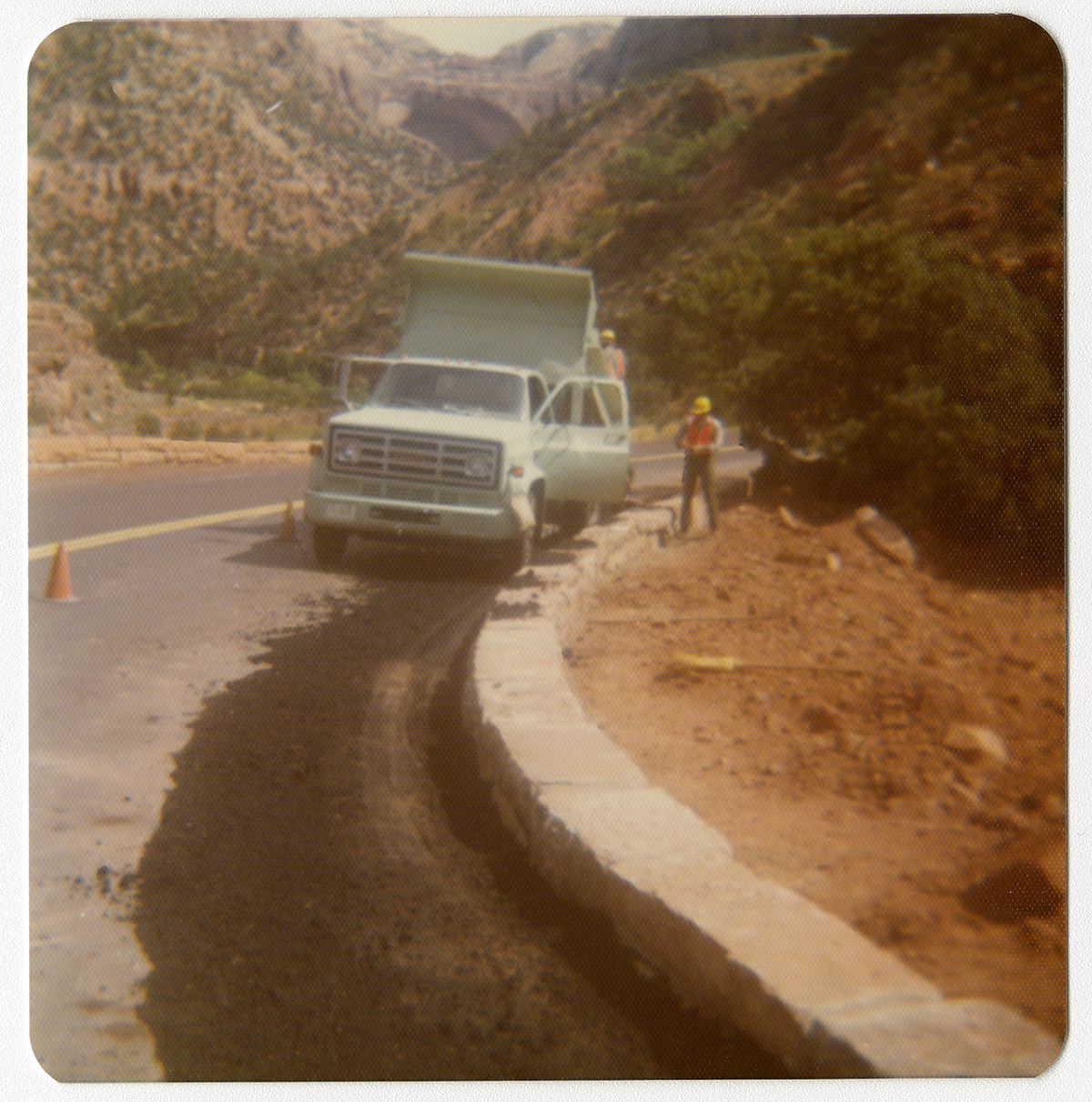 Men work from truck on widening the retaining wall along the Zion-Mt. Carmel Highway switchbacks.