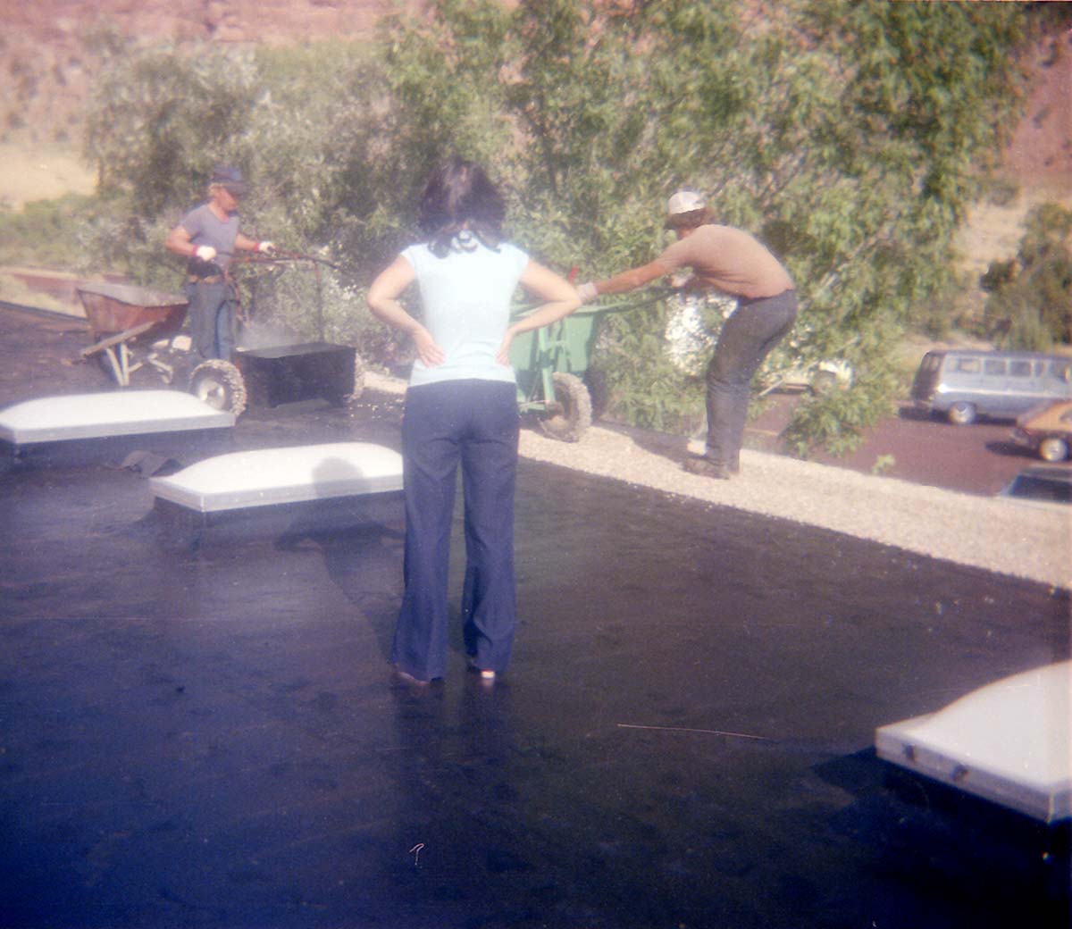 Workers operating roofing machine during the headquarters/visitor center roofing project.