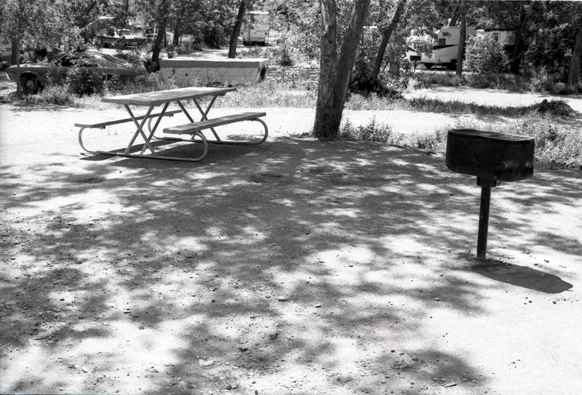 Empty campsite with picnic table and grill in South Campground.