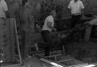 Workers laying cement during the construction of the headquarters addition.