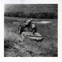 Park employee mowing on the tractor.
