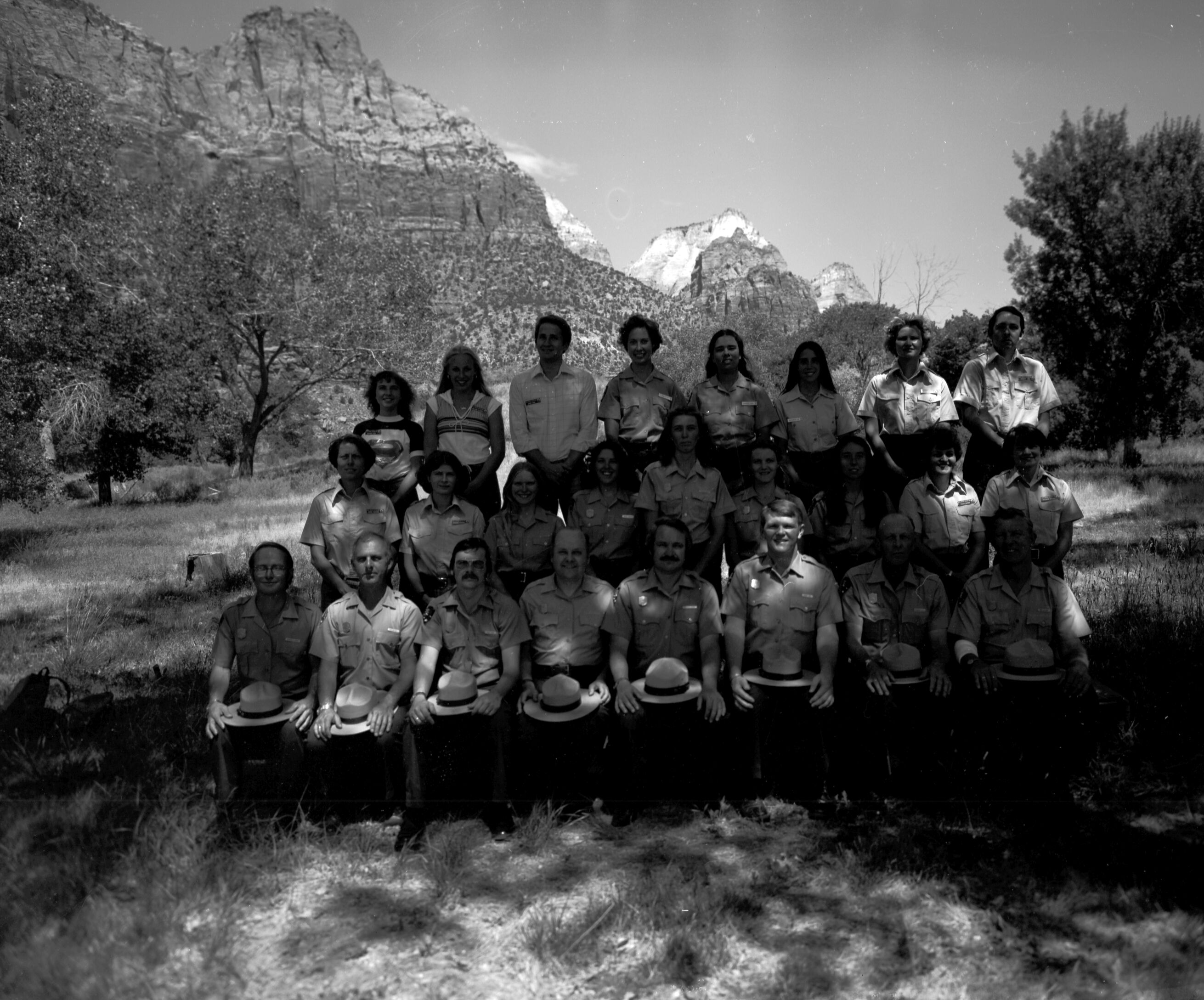 Personnel 1980: naturalist division, Student Conservation Association (SCA), Zion Natural History Association (ZNHA), Zion Nature School (ZNS). Front row (left to right): (two unidentified people), Bob Wood, Victor Jackson, John Lancaster, Roy Given, (two unidentified people). Center row (left to right): Caroline Nicholson, Marion Hilkey, (seven unidentified people). Top row (left to right): Joel Fishbien, Chris Dick, (five unidentified people), Kathy Picarelli.