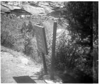 BW Photo of a rock slide along Route 2 - 110mm. Sign damage.